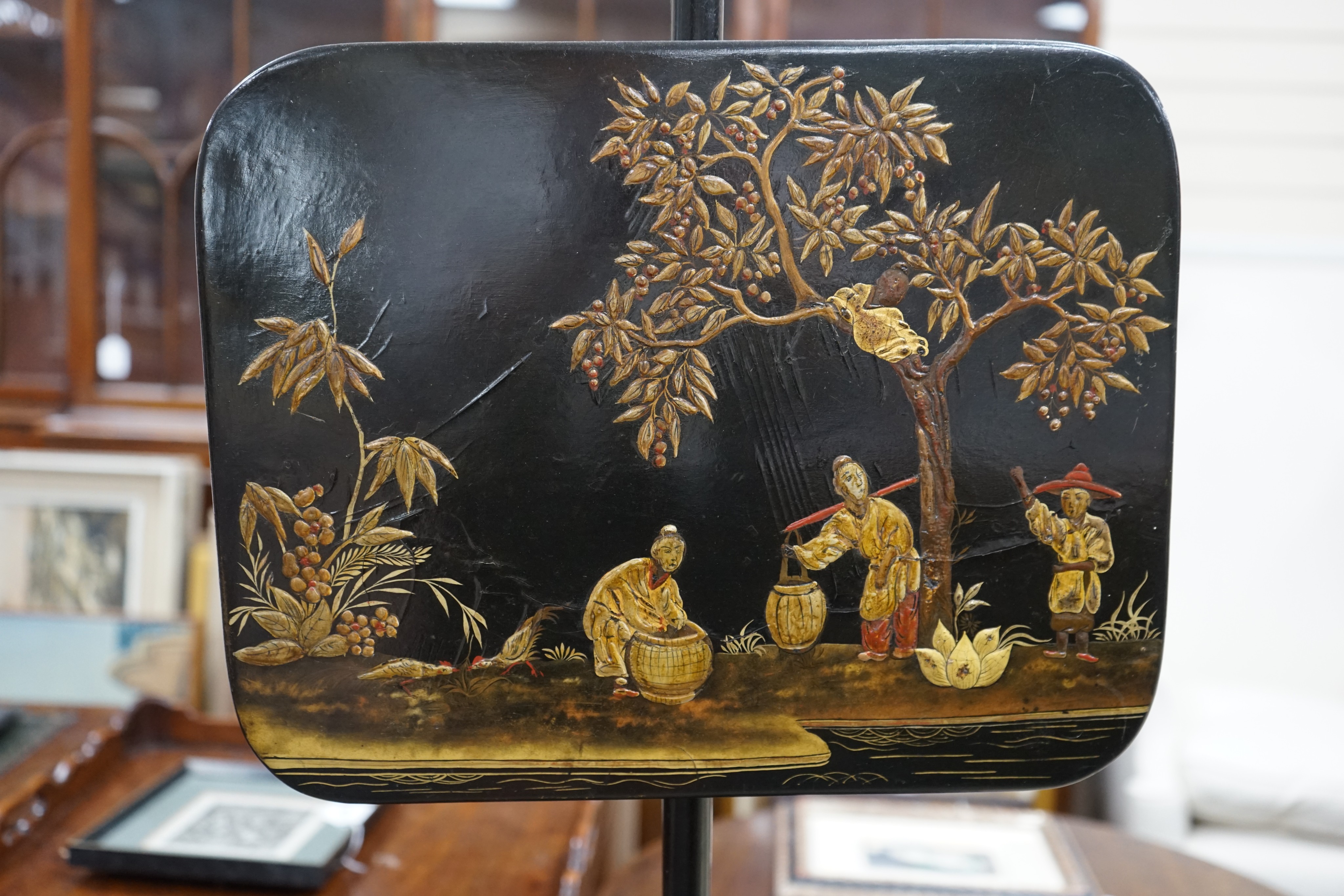 A pair of 19th century chinoiserie lacquer pole screens, height 152cm